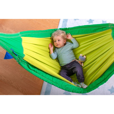 Young child cradled in hammock
