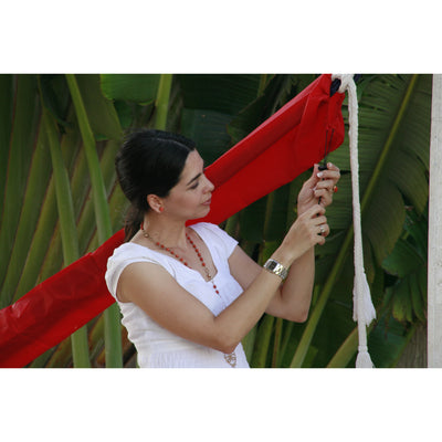 Installing hammock cover on hammock to keep dry and protected from UV damage