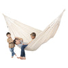 Family playing in large white hammock