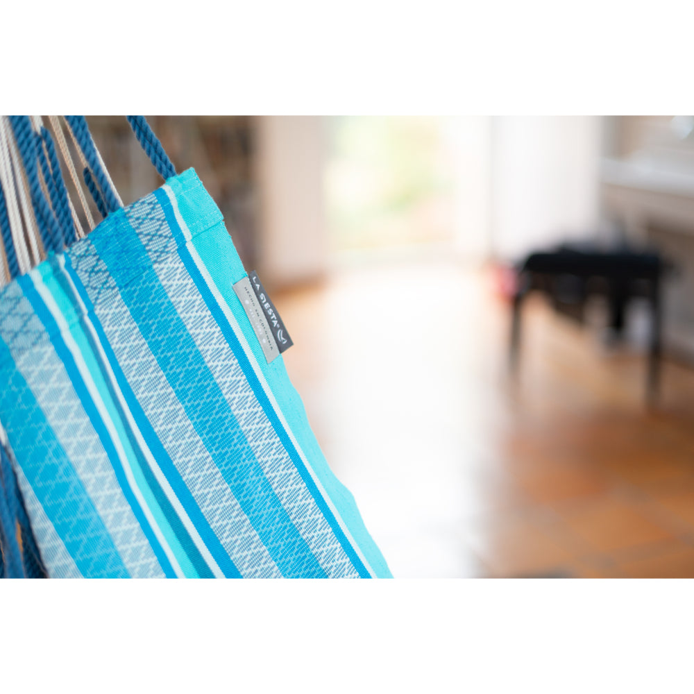 A close-up of a blue and white patterned hammock fabric