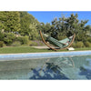 organic cotton hammock on wooden frame near pool