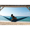 Couple relaxing in hammock on beach