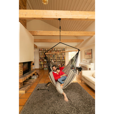 Father and son taking a nap in large hammock chair