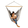 Couple relaxing in large hammock chair together
