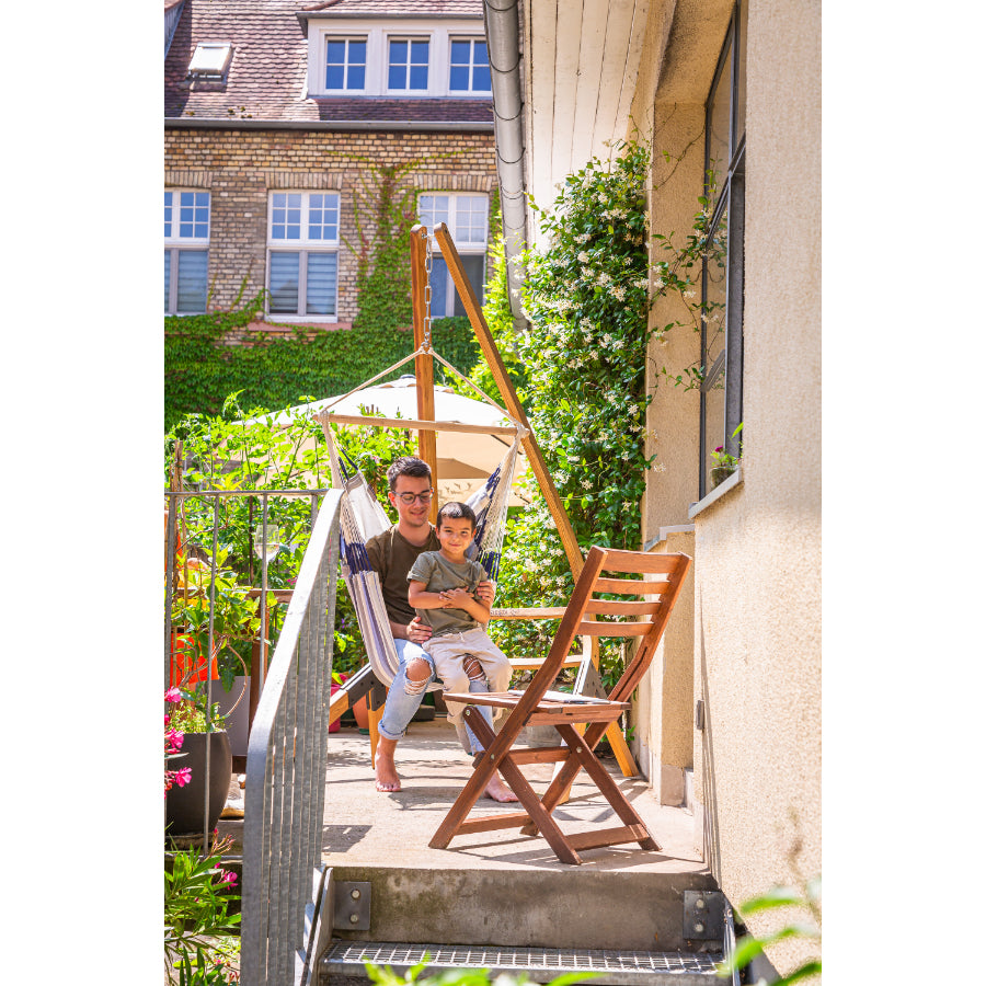 Father and son sitting in hammock chair