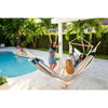 Ladies relaxing in hammocks by swimming pool