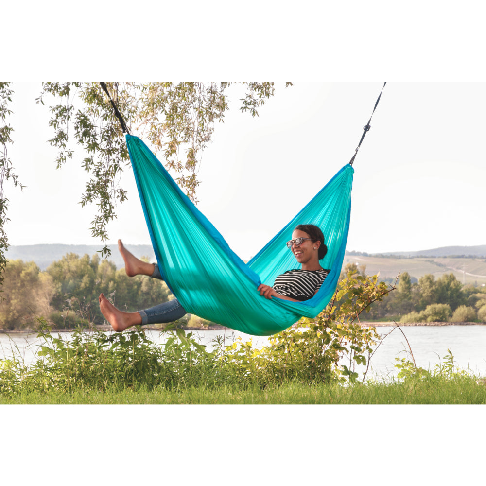 Parachute silk travel hammock hung in garden park