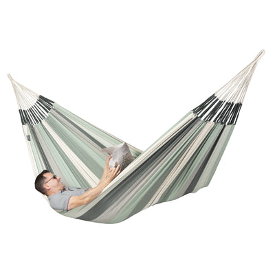 Man reading paper in large hammock