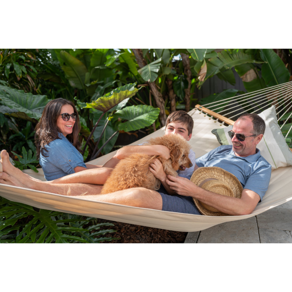 family and dog relaxing in hammock