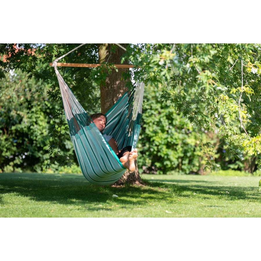 Chair hammock under tree outside