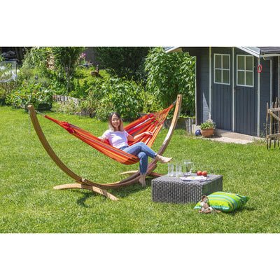 Orange hammock on wooden frame in garden setting