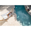 Woman and do relaxing on hammock on wooden stand by swimming pool