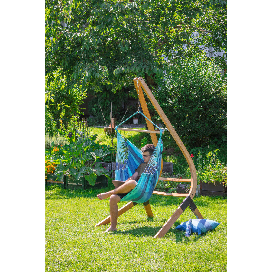 young man in hammock chair in garden