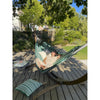 Woman resting in hammock with cushions