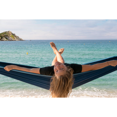 Woman resting in hammock at beach