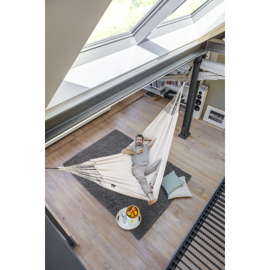 White hammock hanging indoor between support beams