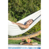 Woman enjoyed relaxing in the sun in a white cotton hammock