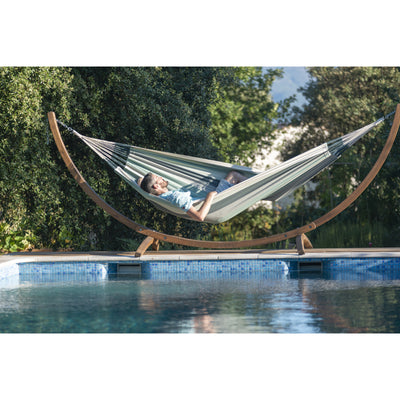 Organic cotton hammock on wooden frame beside swimming pool