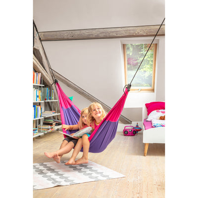 Two children reading a book in a kids hammock